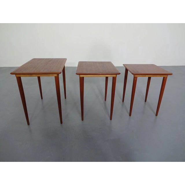 Three teak nesting tables from the 1960s.