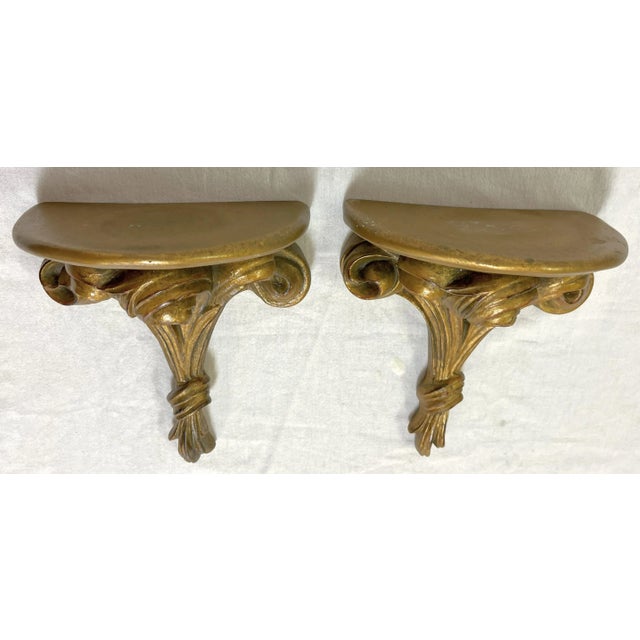 Timeless pair of vintage wall brackets from the mid 20th century. They are made of carved wood with a rose bouquet design...