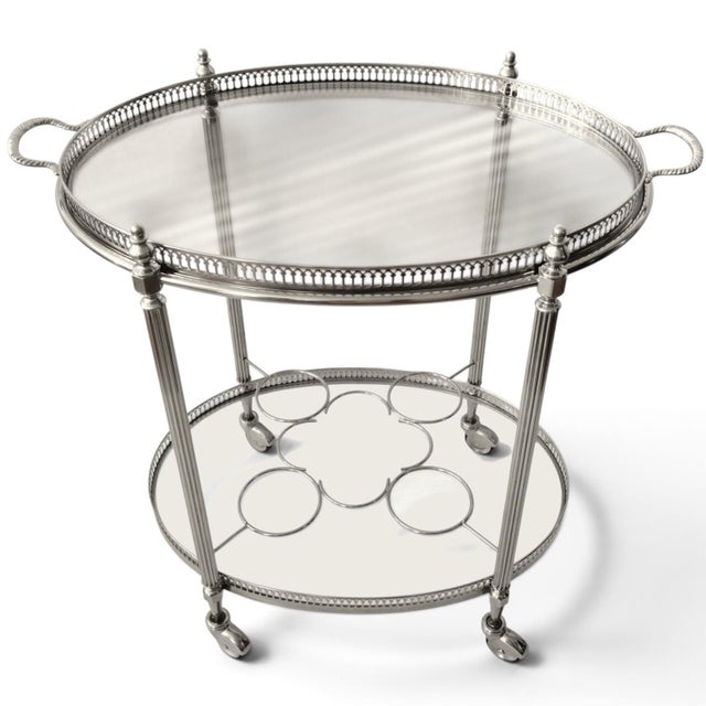 This elegant French vintage oval neoclassical style silver color brass drinks bar cart and serving trolley is a classic...