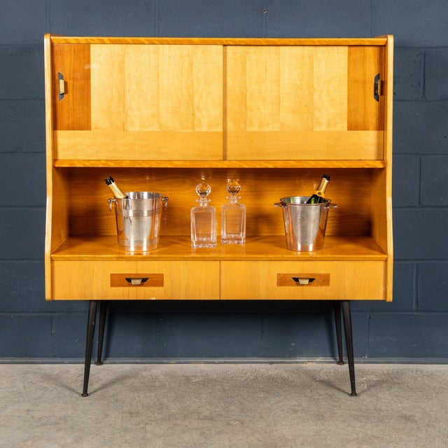 A stylish Italian bar cabinet dating to the 1960s, embodying the clean lines and refined materials that define mid-century...