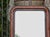 A French Louis-Philippe style mirror from circa 1920 featuring a richly colored faux tortoiseshell frame with rounded...