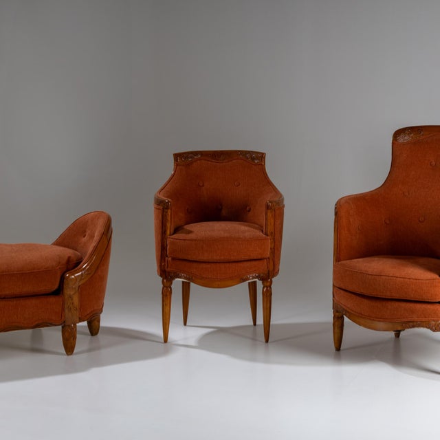 Three-piece Art Nouveau seating ensemble featuring orange upholstery and polished walnut frames with carved floral...