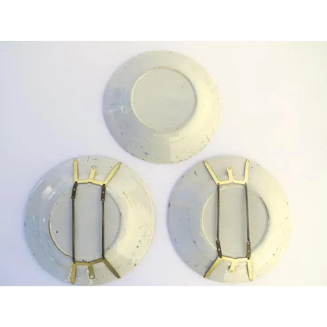 19th century Delft faience, blue and white pottery plates, set of 3. Floral motif. Two plates have adjustable brass...