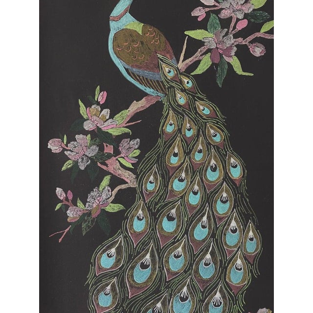 A 1960s acrylic painting of a turquoise peacock with a pink flowering branch on a black ground. Set in a honey toned wood...