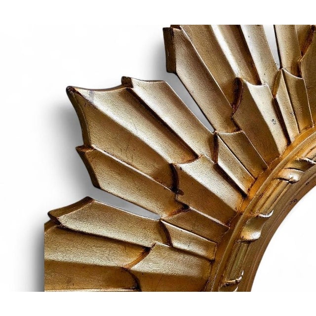 Vintage Mid Century Sunburst Mirror in amazing condition. It is a large wall mirror made of composition material. It is...