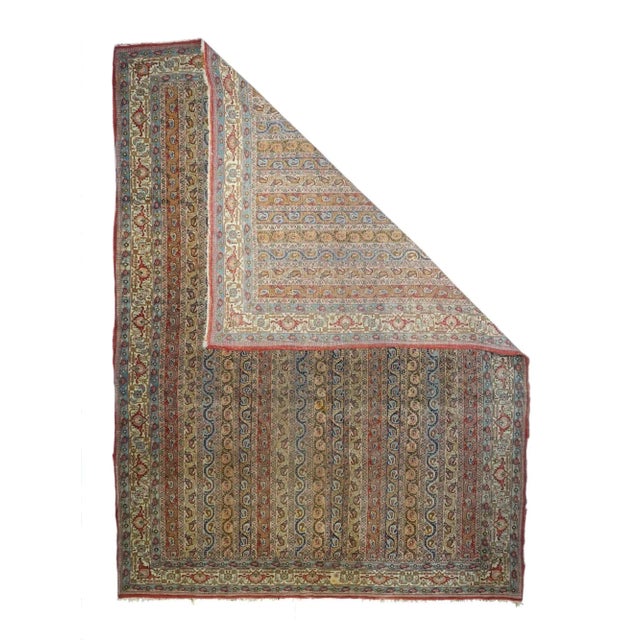 From the central Persian religious center, this finely woven urban carpet shows a "cane" design of vertical stripes in...