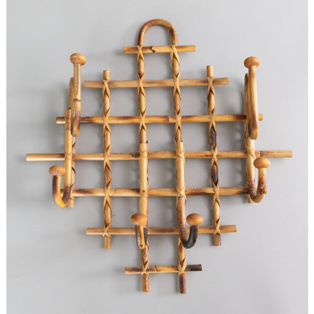 A stylish Mid-Century French rattan and tortoiseshell burnt bamboo bentwood coat and hat rack with six hangers. It's a...