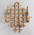 A stylish Mid-Century French rattan and tortoiseshell burnt bamboo bentwood coat and hat rack with six hangers. It's a...