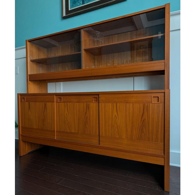 This striking two-piece Danish Modern teak sideboard and hutch was designed and manufactured by the elite workshop of...