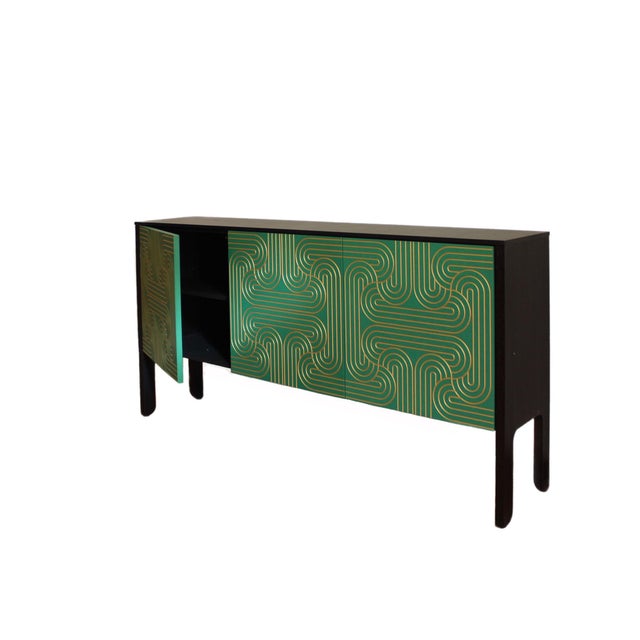 The loop sideboard three door with emerald green doors and a carved pattern hand painted in gold. this piece will add a...