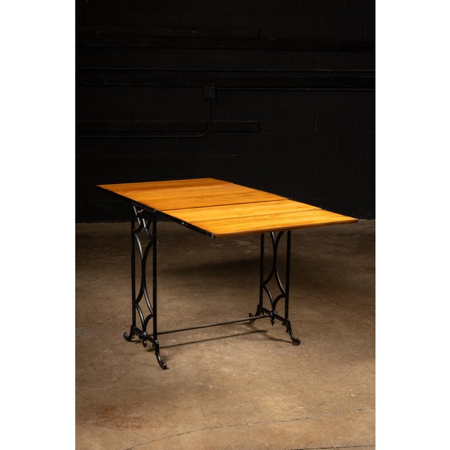 Antique adjustable combination baker's rack and serving table. This piece features five shelves affixed to cast iron...