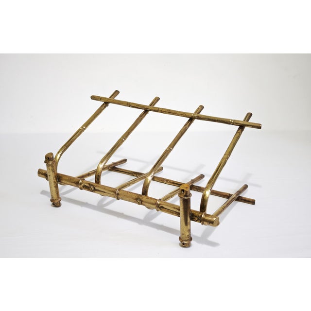 Vintage magazine rack made of faux bamboo brass. It perfectly fits the mid-20th century Hollywood Regency style,...