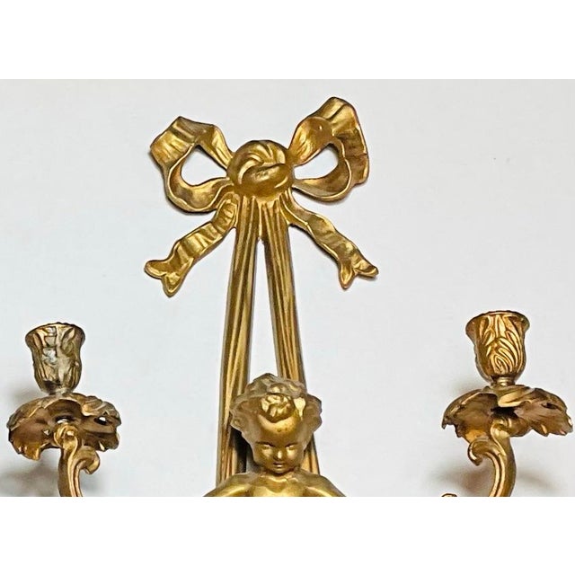 Early 20th Century Pair of Monumental 22” French Louis XVI Style Gilt Bronze Cherub Two-Light Wall Sconces With Ribbon Bows For Sale - Image 4 of 7