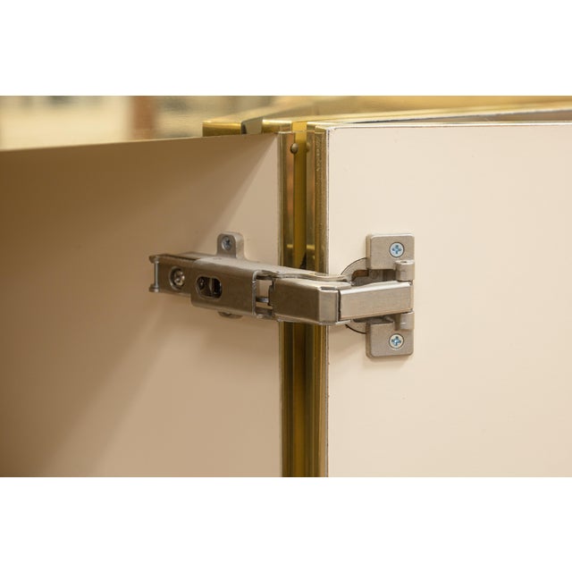 An Ello Furniture brass and beveled mirrors credenza. This is a spectacular piece with a bold Hollywood Regency style from...