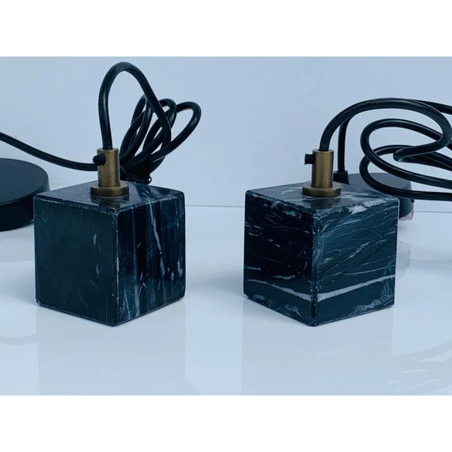Beautiful pair of black marble pendant lights with brass accents. The pieces are in very good condition and with minimal...