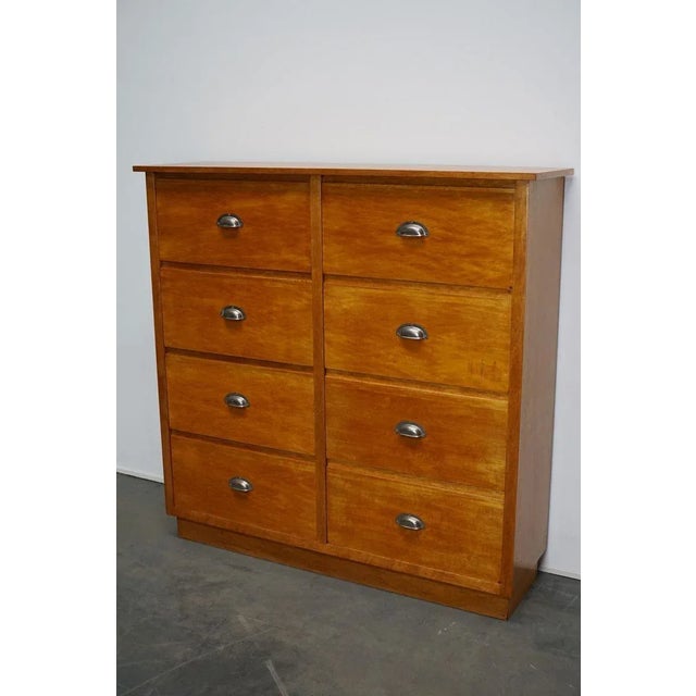 This apothecary with large drawers was made circa 1950s in Germany. It features 8 drawers with sheet metal cup handles. It...