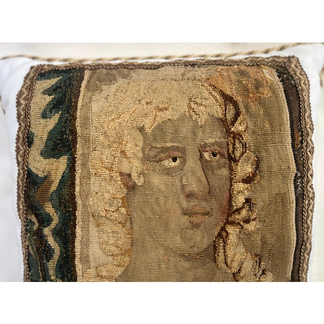 The figure is shown with an elaborate hairstyle reminiscent of the long, flowing and carefully styled hair that was...