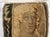 The figure is shown with an elaborate hairstyle reminiscent of the long, flowing and carefully styled hair that was...