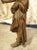 This antique French hand carved wooden statue is of a bearded man wearing a robe tied at the waist with a long scarf...