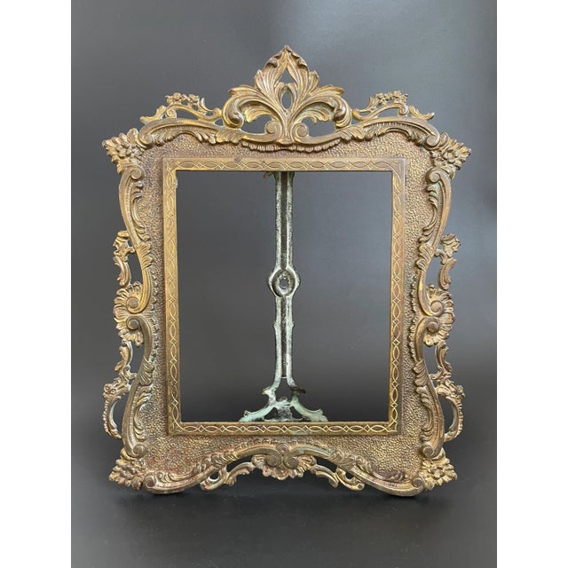 A late 19th Century Victorian easel back picture/photo frame crafted by the National Brass & Iron Works. This sturdy gilt...