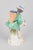 Meissen, grape boy figurine. Porcelain figurine depicting a boy carrying a basket filled with grapes on his back, finely...