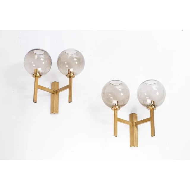 Rare model, produced in Sweden, 1960s. Smoked glass shades and brass. 2 available. This piece is attributed to the...