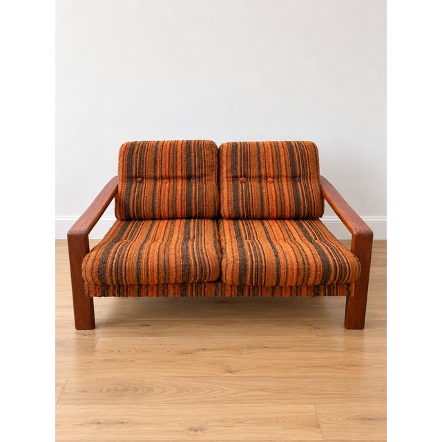 Vintage Scandinavian living room set from the 1970s, comprising a two-seater sofa and a matching armchair. This set exudes...