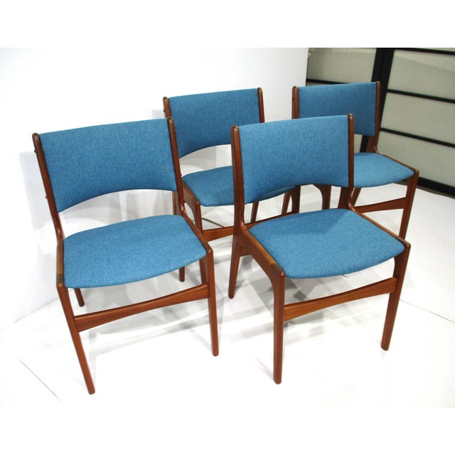 A set of four very well -crafted Mid Century teak wood framed dining chairs with tight woven blue toned contract fabric by...