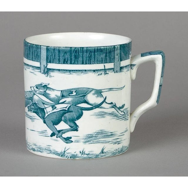 Staffordshire blue (teal) and white mug decorated with greyhounds chasing a hare. Mark on bottom: “Greyhounds” Leighton...