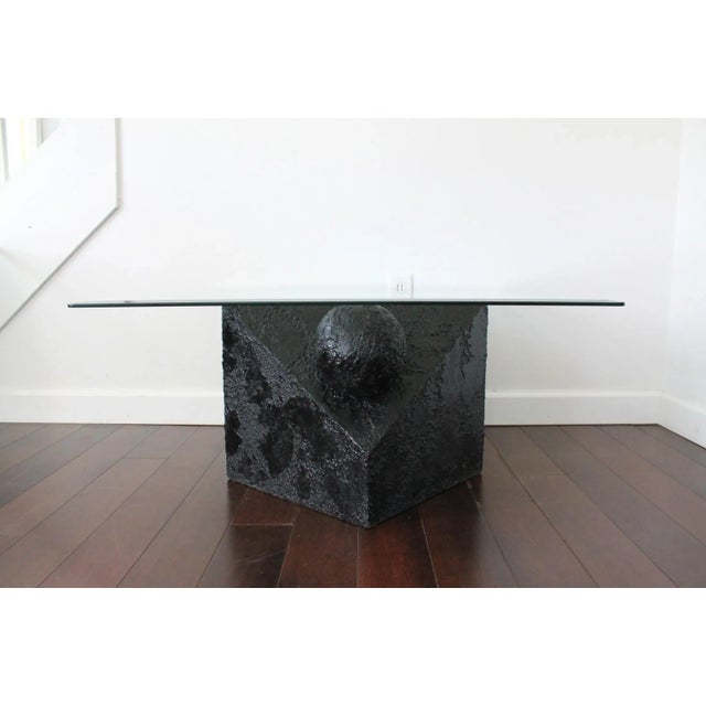 Beautiful set of 80's Postmodern faux stone coffee table and two side tables. Textured table bases in a semi-gloss black...