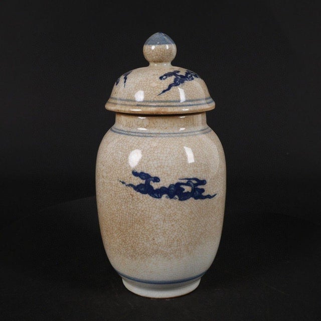 Decorative small lidded melon jar finished in aged‑style crackle porcelain glaze. The body features a classic Chinese...