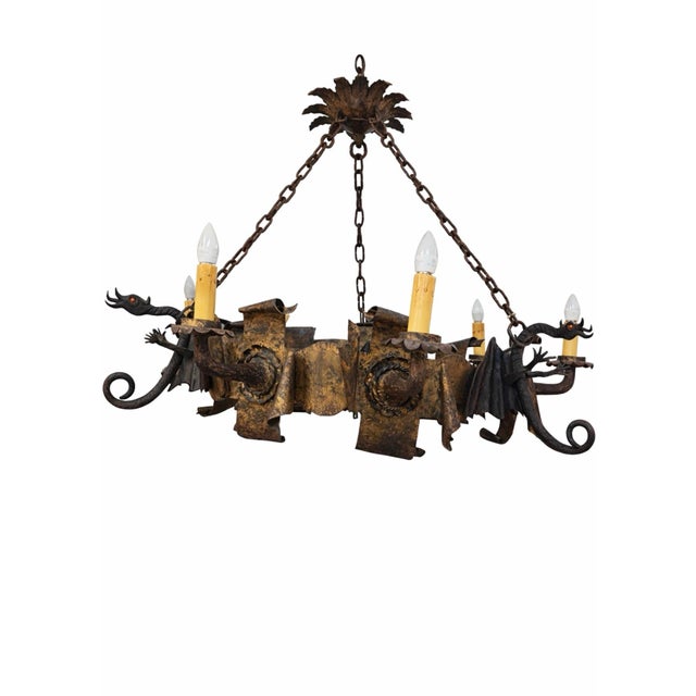 A truly exceptional and highly sculptural Gothic Revival chandelier featuring dramatic dragon figures emerging from a...