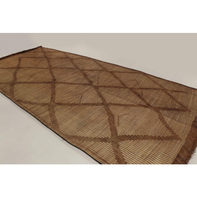 This vintage Moroccan mat is a primitive 9x20 Tuareg work from the nomadic tribe of the same name. Handwoven with reeds...