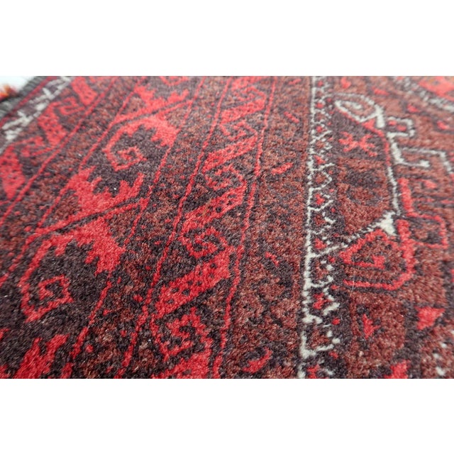 An exceptional Vintage Afghan Baluch Runner Rug hand-knotted by nomadic weavers in Afghanistan. Baluch runner rugs are...