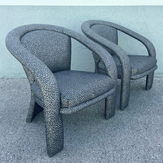 A striking pair of postmodern lounge chairs, defined by their sculptural silhouette and bold, fashion-forward upholstery....