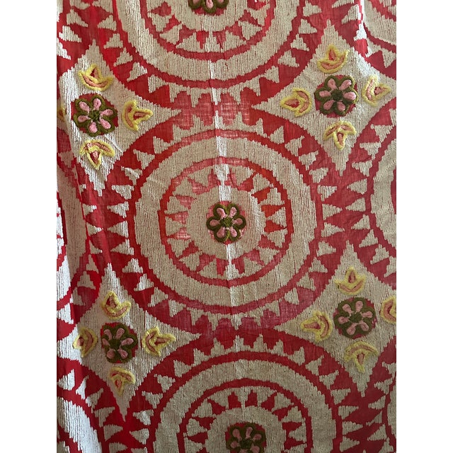 Drenched in bold 1950s charm, this vintage red suzani chenille blanket is a true showstopper. The richly textured chenille...