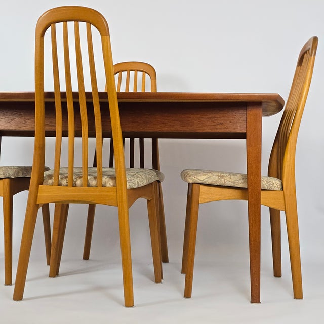 Vintage MCM teak solid-wood table and 4 highback dining chairs. Designed in Denmark by Benny Linden and produced in...