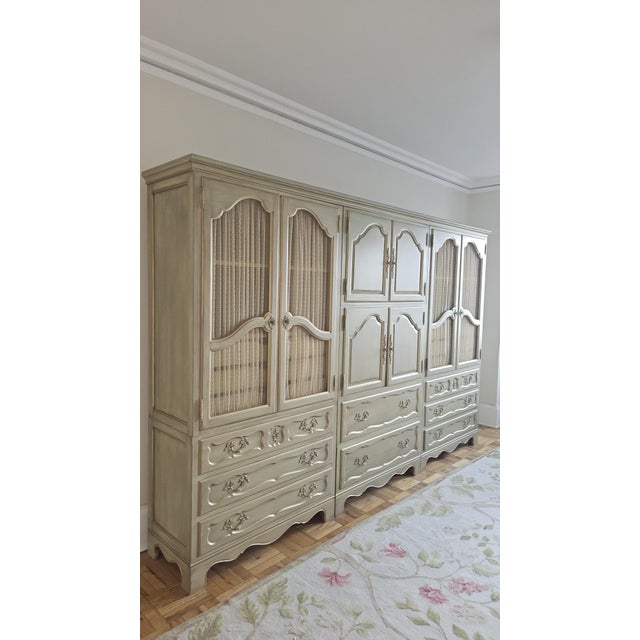 Elegant Louis XV inspired triple-armoire wall unit by Baker Furniture with continuous crown for a seamless built-in feel....