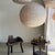Large, round, pale pink Japanese-style rattan and natural linen pendant light. Beautifully handcrafted: natural rattan and...