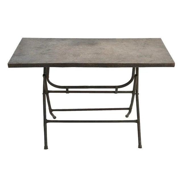 Patinated Iron Folding Table, in Good conditions. This piece is designed in the style of the selected designer and/or...