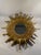 A very glamorous French Style Gilded Sunburst Wall Mirror from the 1960s. This fabulous 17.25" mirror features various...