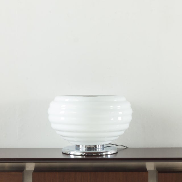 This sculptural italian table lamp closely resembles the style of achille castiglioni, one of the most influential figures...