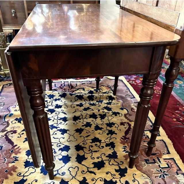 Drop-leaf breakfast or dining table. English mahogany. Georgian period, circa 1790-1800. Top swivels to drop leaf down....