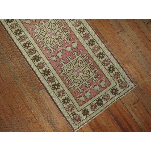 Mid-20th century Turkish runner in predominant soft pink. Narrow and long. Measures: 1'11” x 14'1”.