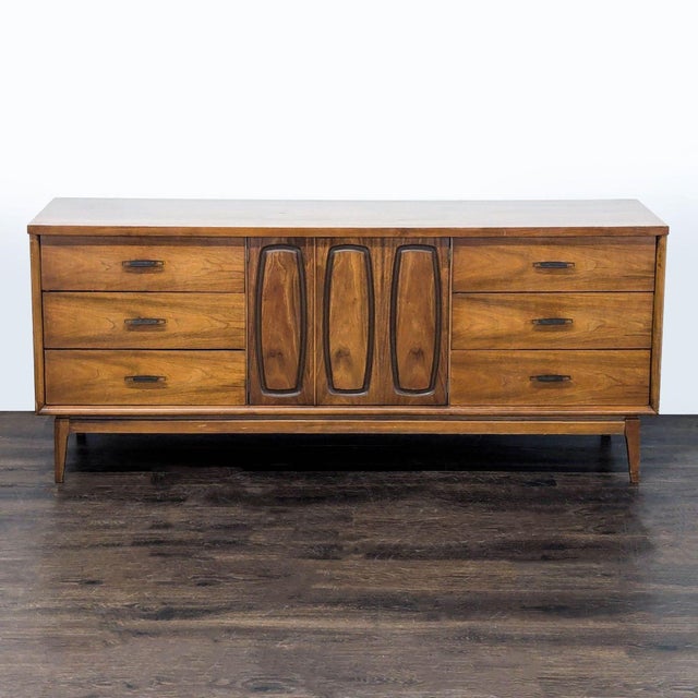 Mid Century walnut credenza / server with three drawers at each end with metal pulls. The two center doors open to three...