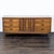 Mid Century walnut credenza / server with three drawers at each end with metal pulls. The two center doors open to three...