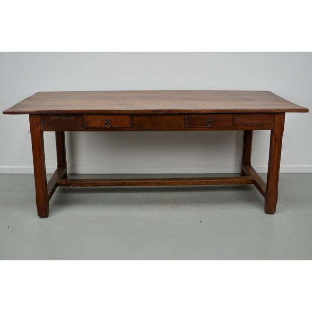 This elegant table was made in France in the 20th century. The table was made in oak & elm with beautiful grain patterns....