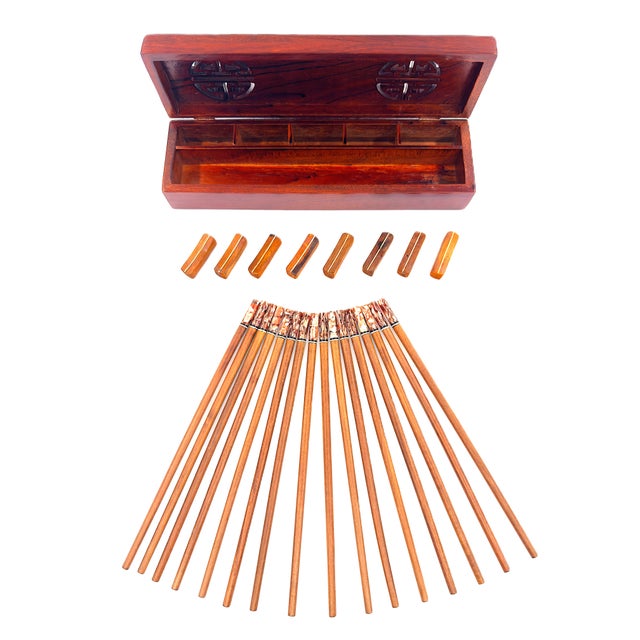 A beautiful handmade set of chopsticks finished in a warm, natural wood grain complemented by striking brown and ivory...