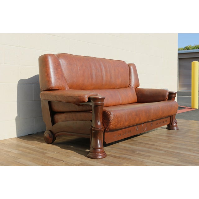 Exceptional vintage 1970s brown leather sofa featuring a substantial sculptural wood frame paired with beautifully...