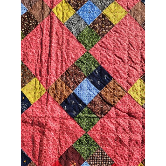 19th C Nine patch chain with a saw tooth border. This early Pennsylvania nine patch is in fine condition.